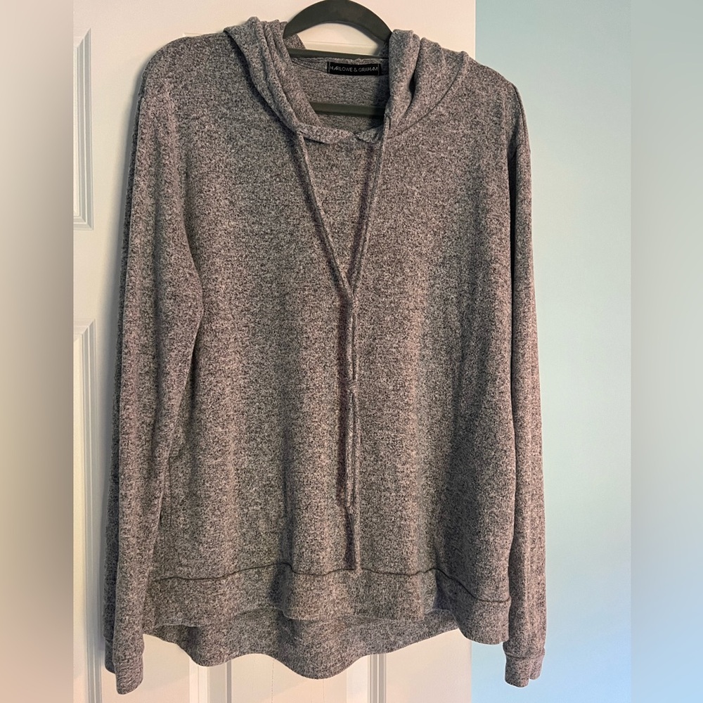 Gray lightweight sweater with hood and pockets in the front.  Great for fall!